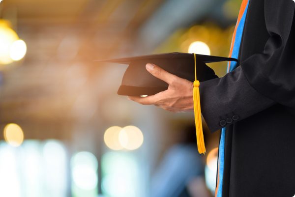 graduation-take-black-yellow-tassel-front-bokeh-blurry-background