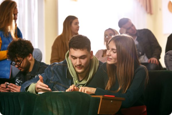 group-cheerful-happy-students-sitting-lecture-hall-before-lesson 1